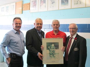 The public's help is being sought for a plan to upgrade and expand the 'Wall of Fame' display at Sarnia Arena. Shown discussing the scheme are, from left: Rob Harwood, Sarnia's manager of arena facilities, president Don Burnard of the Seaway Kiwanis Club, Greg Burr of the Sarnia Legionnaires and Jerry MacPhee, a past president of Seaway Kiwanis. (HANDOUT/ SARNIA OBSERVER/ POSTMEDIA NETWORK)