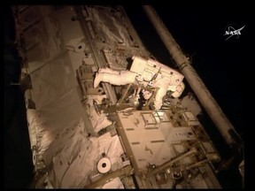This NASA TV image obtained November 6, 2015 shows astronaut Scott Kelly as he makes an inspection on the International Space Station. Two U.S. astronauts stepped out on a risky spacewalk Friday to complete the repair of an ammonia cooling system at the International Space Station. Highly toxic ammonia is used to cool electronics at the orbiting outpost, and the thermal system has been plagued by problems. Friday's outing aims to complete the final repairs to a system that broke down about three years ago. Scott Kelly and Kjell Lindgren switched their spacesuits to battery power at 6:22 am (1122 GMT) and floated outside the orbiting outpost moments later, according to a live broadcast on NASA television. (AFP PHOTO/NASA TV)
