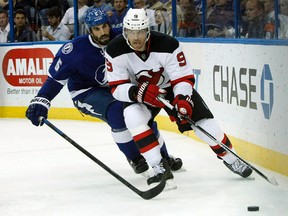 New Jersey Devils right winger Martin Havlat skates with the puck as Tampa Bay Lightning defenceman Jason Garrison defends during the first period at Amalie Arena on Oct. 14, 2014. (Kim Klement/USA TODAY Sports)