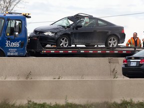 The driver of this westbound car was killed when it was struck by a tire that snapped off an eastbound truck on HWY 401 just west of Putnam Road in Dorchester, Ont. on Friday November 6, 2015. Derek Ruttan/The London Free Press/Postmedia Network