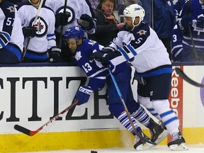 Nazem Kadri of the Toronto Maple Leafs gets hit from behind by Mark Stuart of the Winnipeg Jets at the Air Canada Centre in Toronto on Nov. 4, 2015. (Dave Abel/Toronto Sun/Postmedia Network)