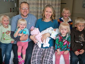 Tiffany and Chris Goodwin of Three Forks, Mont., pose for a family photo with their children, from left, Eliza, Brielle, Olivia, Carter, Mason, Emalynn and Josh on Wednesday, Nov. 4, 2015 at the Bozeman Health Deaconess Hospital in Bozeman, Mont. Tiffany gave birth to her third set of twins, Olivia and Carter, on Monday. (AP Photo/Bozeman Daily Chronicle, Adrian Sanchez-Gonzalez)