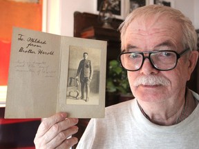 Ian Sutton holds a photo of his uncle, Harold Phillips, who lied about his age to enlist in the army in the First World War but died three days after the armistice was signed. (Michael Lea/The Whig-Standard)