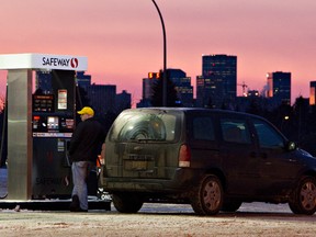 A motorist fuels up at a Safeway pump in Edmonton, Alberta. FILE PHOTO/EDMONTON SUN