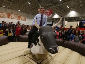 Toronto Mayor John Tory took a turn on the mechanical bull at the opening of the Royal Agricultural Winter Fair on Nov. 6, 2015. (Jack Boland/Toronto Sun)