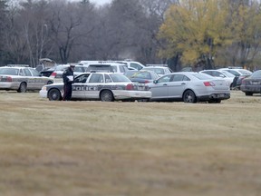 Following a chase, the police shot a man at Grant Avenue and Kenaston Blvd, in Winnipeg.  The man's bullet ridden vehicle was surrounded by phalanx of police vehicles for several hours, after the shooting.  Friday, November 6, 2015.   Sun/Postmedia Network