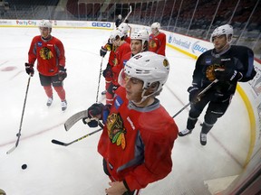 Chicago Blackhawks forward Patrick Kane works out with teammates during a morning skate prior to facing the New Jersey Devils in Newark, NJ on Nov. 6, 2015. (AP Photo/Julio Cortez)