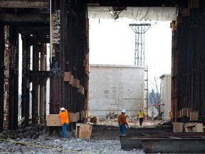 Workers wire and attach explosives to the steel support beams of the former power plant Thursday, Nov. 5, 2015 in Marysville, Mich. The implosion scheduled for 8 a.m. Saturday. (Jeffrey M. Smith/The Times Herald via AP)