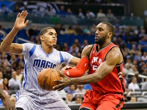 Toronto Raptors forward Patrick Patterson, right, passes the ball around Orlando Magic forward Tobias Harris during the first half of an NBA basketball game, Friday, Nov. 6, 2015, in Orlando, Fla. (AP/John Raoux)