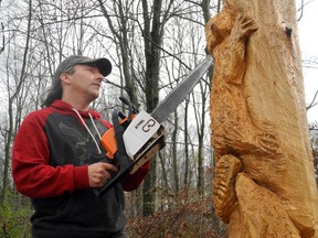 Chainsaw carver Kane Sibley has sculpted a wooden monument from a dead ash tree to keep watch over the Mt. Brydges cemetery where many of his relatives and friends are buried. (DEBORA VAN BRENK, The London Free Press)