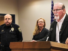 Canon City Police Chief Paul Schultz, left, and Crime Prevention Coordinator Jen O'Connor listen as Superintendent George Welsh talks about a sexting scandal at Canon City High School during a news conference in Canon City, Colo., on Friday, Nov. 6, 2015. An unspecified number of students have been suspended and the school forfeited its final football game of the season because of the number of players involved. (Tracy Harmon/The Pueblo Chieftain via AP)