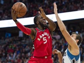 Minnesota Timberwolves forward Nemanja Bjelica, right, pressures Toronto Raptors forward DeMarre Carroll as he drives to the basket Wednesday, October 14, 2015 in Ottawa. (THE CANADIAN PRESS/Adrian Wyld)