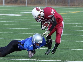 St. Charles running back Joel Brunet tries to get past Superior Heights defender Gabe Spina during the NOSSA junior boys football final at James Jerome Sports Complex in Sudbury, Ont., on Saturday, November 7, 2015.