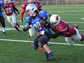 Superior Heights Steelhawks' Max Fisher gets tackled by St. Charles Cardinals' Andrew Kohut during NOSSA senior boys semifinal action at James Jerome Sports Complex on Saturday afternoon.