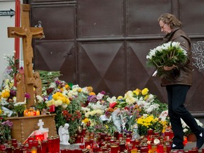 Dutch violinist and conductor Andre Rieu lays flowers outside the Colectiv nightclub in Bucharest, Romania, Saturday, Nov. 7, 2015. Seven more people have died a week after a fire broke out in a Bucharest nightclub. About 100 other people still remain hospitalized, of which 48 are in a serious or critical condition, from the Oct. 30 blaze that erupted at the Colectiv nightclub during a heavy-metal concert.(AP Photo/Vadim Ghirda)