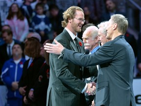 Hall-of-Famer Chris Pronger shakes hands with Hockey Hall of Fame officials prior to NHL hockey action between the Toronto Maple Leafs and the Detroit Red Wings, in Toronto, on Friday, November 6, 2015. (THE CANADIAN PRESS/Nathan Denette)