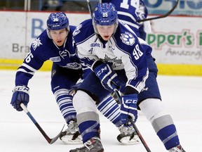 Mississauga Steelheads Austin Osmanski keeps in close check with Sudbury Wolves Dmitry Sokolov during first period OHL action from the Sudbury Community Arena on Saturday. Gino Donato/The Sudbury Star/Postmedia Network