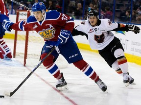 The Edmonton Oil King's Dysin Mayo (37) battles the Calgary Hitmen's Beck Malenstyn (11) during second period WHL action at Rexall Place, in Edmonton, Alta. on Saturday Nov. 7, 2015. David Bloom/Edmonton Sun/Postmedia Network