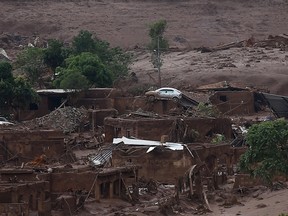 The Bento Rodrigues district is pictured covered with mud after a dam owned by Vale SA and BHP Billiton Ltd burst in Mariana, Brazil, November 6, 2015. Casualties from the collapsed dam at a Brazilian mine owned by Vale and BHP Billiton mounted on Friday after rescue teams worked through the night to find the dozens missing in mudslides that devastated a nearby village. A spokesman for firefighters in the rescue confirmed 30 injuries and at least two deaths, but said the count was likely to rise as the search advanced slowly after mudslides knocked out roads and cellular towers. REUTERS/Ricardo Moraes