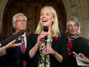 Minister of Environment and Climate Change Catherine McKenna speaks to reporters in the foyer on Parliament Hill after being sworn in earlier in the day, on Wednesday, Nov. 4, 2015, in Ottawa. (THE CANADIAN PRESS/Justin Tang)