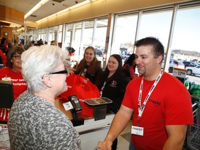 Allen Magee, from the local chapter of MADD, greets a customer as she leaves Metro.