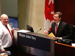 Councillor Rob Ford talks to Mayor John Tory during council meeting December 3, 2014. (Michael Peake/Toronto Sun)