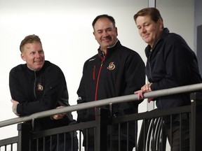 The Ottawa Senators senior advisor of hockey operations Daniel Alfredsson, left, speaks with assistant general manager Pierre Dorion, center, and assistant general manager Randy Lee at the Ottawa Senators NHL training camp in Ottawa on Friday, Sept. 18, 2015. THE CANADIAN PRESS/Patrick Doyle