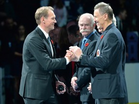Hall-of-Famer Nicklas Lidstrom, left, shakes hands with Hockey Hall of Fame officials prior to NHL hockey action between the Toronto Maple Leafs and the Detroit Red Wings, in Toronto, on Friday, November 6, 2015. THE CANADIAN PRESS/Nathan Denette