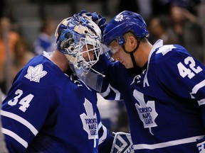 Toronto Maple Leafs forward Tyler Bozak (42) congratulates Toronto Maple Leafs goaltender James Reimer (34) after a win at the Air Canada Centre. Toronto defeated Dallas 4-1.  John E. Sokolowski-USA TODAY Sports