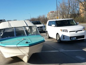 A fibreglass boat was parked on Chief Peguis Trail at Henderson Highway for about an hour on Sunday, Nov. 8, 2015. (Photo by Russ Young)