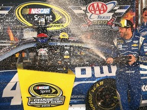 Jimmie Johnson, driver of the #48 Lowe's Chevrolet, celebrates with champagne in Victory Lane after winning the NASCAR Sprint Cup Series AAA Texas 500 at Texas Motor Speedway on November 8, 2015 in Fort Worth, Texas.   Sarah Crabill/Getty Images for Texas Motor Speedway/AFP