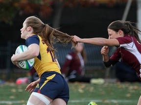 Emma Chown of the Queen's Gaels gets her hair pulled by McMaster Marauders’ Rina Charalampis during the Canadian Interuniversity Sport women’s rugby gold-medal game at Nixon Field at Queen's University on Sunday. Queen's lost 27-3. (Ian MacAlpine/The Whig-Standard(
