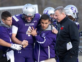 Western Mustangs quarterback Will Finch was taken off the field by staff after being hit. (CRAIG GLOVER, The London Free Press)
