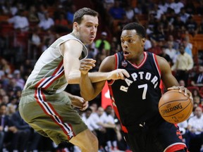 Toronto Raptors guard Kyle Lowry (7) drives past Miami Heat guard Goran Dragic (7) in the first quarter of an NBA basketball game, Sunday, Nov. 8 2015, in Miami. (AP Photo/Joe Skipper)