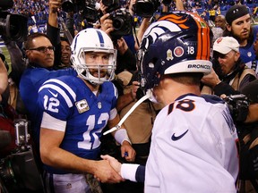 Indianapolis Colts quarterback Andrew Luck (12) shakes hands after the game with Denver Broncos quarterback Peyton Manning (18) at Lucas Oil Stadium. Indianapolis defeats Denver 27-24. Brian Spurlock-USA TODAY Sports