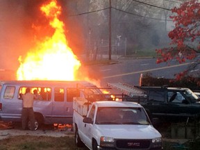 Flames rise from a vehicle following a fatal crash Sunday, Nov. 8, 2015, in Hyattsville, Md. The accident occurred late Sunday afternoon on a road in Hyattsville just northeast of Washington. (Steve Ramsey via AP)