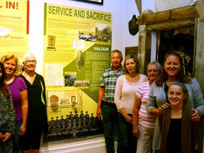 Four generations of World War I veteran Layton Smith's family crowed into the Stratford Perth Museum's World Wars room to see, for the first time, the Perth Regiment exhibit, featuring a picture of Smith accompanied by a timeline of his wartime journey through England and France. Pictured (from left): Maggie Schweitzer (great granddaughter), Shannon Schweitzer (granddaughter), Marg Illman (daughter), Ken Smith (son) Krista Henderson (granddaughter), Barb Smith (daughter), Juanita Belfour (granddaughter) and Maya Belfour (great granddaughter). GALEN SIMMONS/MITCHELL ADVOCATE