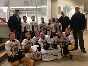 Members of the Mitchell Novice reps celebrate their championship in the Goderich tournament this past weekend. SUBMITTED
