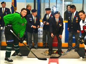 World War II veteran Bill Cornish conducted the ceremonial puck drop at the Mitchell Hawks game for Remembrance this past Saturday, Nov. 7 at the Mitchell Arena against Walkerton. Taking the face off was Hawks’ captain Tyler Pauli (left), wearing a special Legion jersey, and Walkerton’s Chris Gillman (12). GALEN SIMMONS/MITCHELL ADVOCATE
