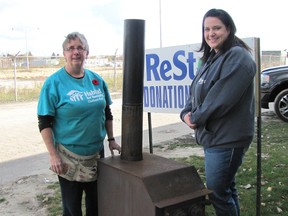 Habitat for Humanity ReStore volunteer Nancy DuChene and office and volunteer manager Anne Taylor check out a wood stove that was recently donated. Habitat is always looking for volunteers at the Riverview Drive facility.