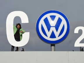 Greenpeace activists demonstrate as they stand on top of Volkswagen's "Sandkamp" gate in Wolfsburg, Germany, November 9 , 2015. REUTERS/Fabian Bimmer