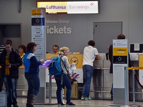 Passengers line up at a Lufthansa counter at the airport in Duesseldorf, Germany, Monday , Nov. 9, 2015. Lufthansa said some 113,000 passengers will be affected by 929 domestic and international flight cancellations due to all-day strikes at three German airports staged by a union representing cabin crew. (AP Photo/Martin Meissner)