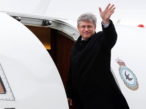 Prime Minister Stephen Harper waves as he boards the Challenger jet Tuesday Sept 21, 2010 at the Canada Reception Centre in Ottawa. (Postmedia Network files)