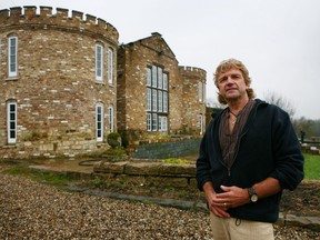 In this Feb. 3, 2010 file photo, farmer Robert Fidler stands outside the mock Tudor castle home at Honeycrock Farm, Salfords, England. (Gareth Fuller/AP, File)