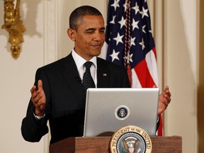 U.S. President Barack Obama reacts after tweeting at his first ever Twitter Town Hall in the East Room at the White House in Washington in a July 6, 2011 file photo. The White House launched a Facebook page on November 9, 2015 for President Barack Obama and used the social media platform to send a message on climate change. (REUTERS/Larry Downing)