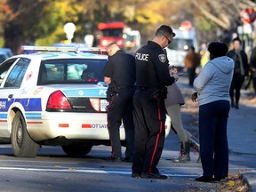 Ottawa Police investigate a shooting at the corner of Besserer St and Chapel Street in Ottawa Ontario Monday Nov 9, 2015. A 16 year old boy was sent to hospital with gunshot wounds. Police talk to witnesses at the scene  Monday.  Tony Caldwell/Ottawa Sun/Postmedia Network