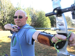 Ralph Kennedy, president of the Kingston Archery Club, aims his bow at the club's outdoor range on Battersea Road in Kingston on Tuesday. Archers on TV and in movies have prompted an increased interest in the sport. (Michael Lea/The Whig-Standard)