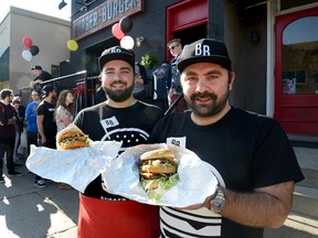 Victor Anastasiadis, left, and his brother, Kirk, stand in front of their new Burger Burger restaurant on Richmond Street. The eatery features burgers based on a blend of sirloin, chuck and brisket. (MORRIS LAMONT, The London Free Press)