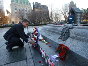 Mohamed Fahmy leaves a wreath at the War Memorial Monument on Elgin St., Monday, November 9, 2015. Fahmy, age 41, is an Egyptian-born Canadian award-winning journalist and author. Fahmy has worked extensively in the Middle East, mostly for CNN. He was released from an Egyptian prison this past summer. 
MIKE CARROCCETTO/Ottawa Sun