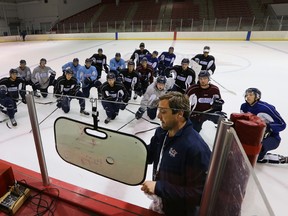 Flint Firebirds head coach John Gruden is shown with his players at the Iceland Arena in Flint, Mich. during practice Sept. 9. Gruden and his staff were abruptly fired Sunday night, but rehired Monday after the players quit the Ontario Hockey League team. (DAN JANISSE, Postmedia Network)